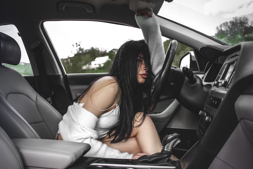 a woman sitting in the passenger seat of a car