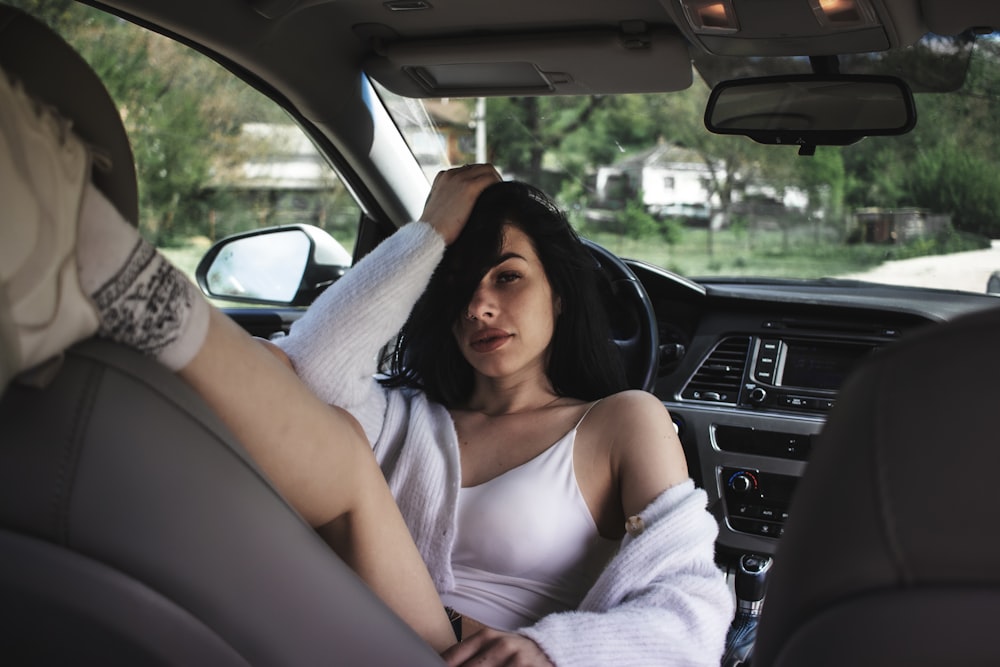 a woman sitting in the passenger seat of a car