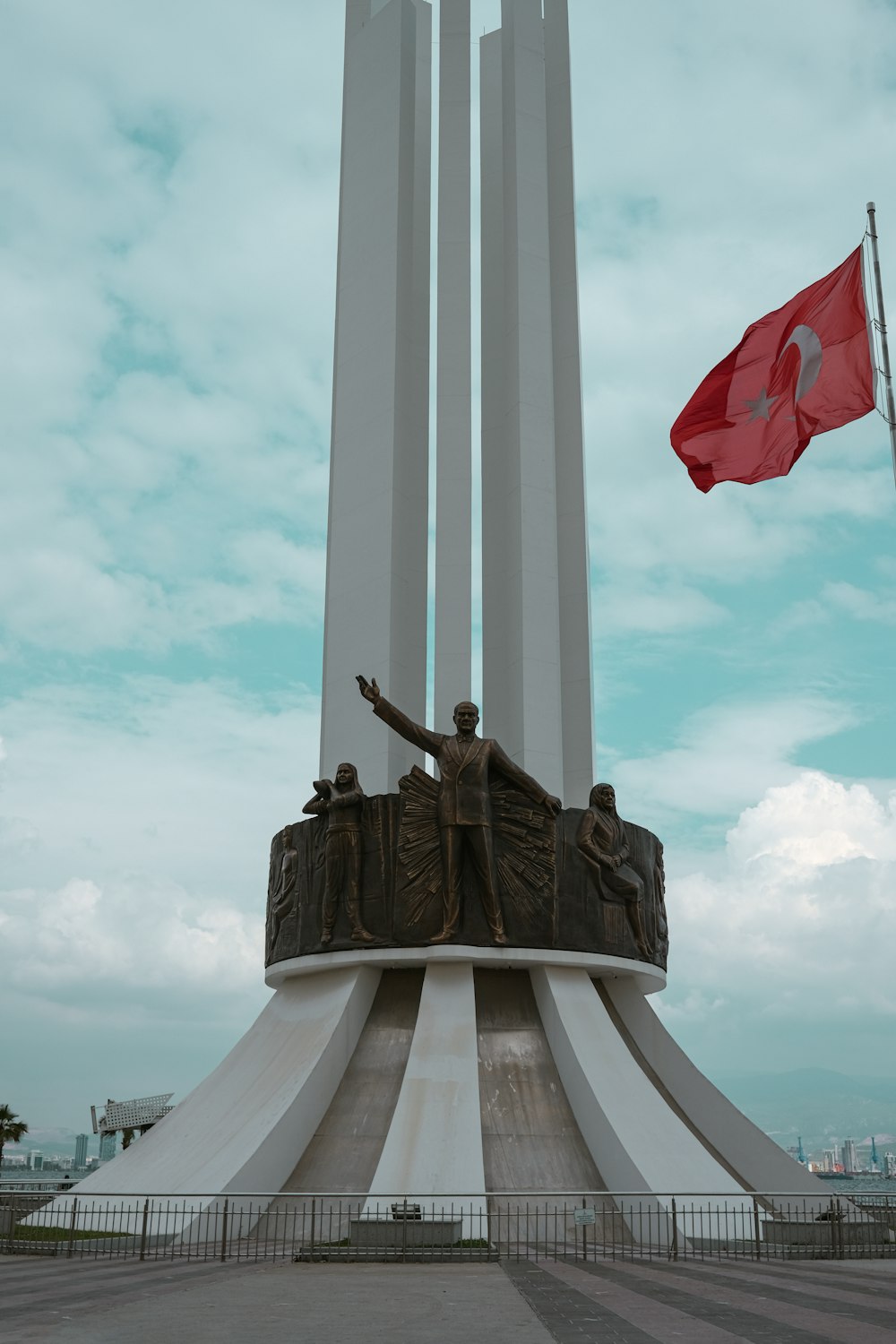 a large monument with a flag flying in the background