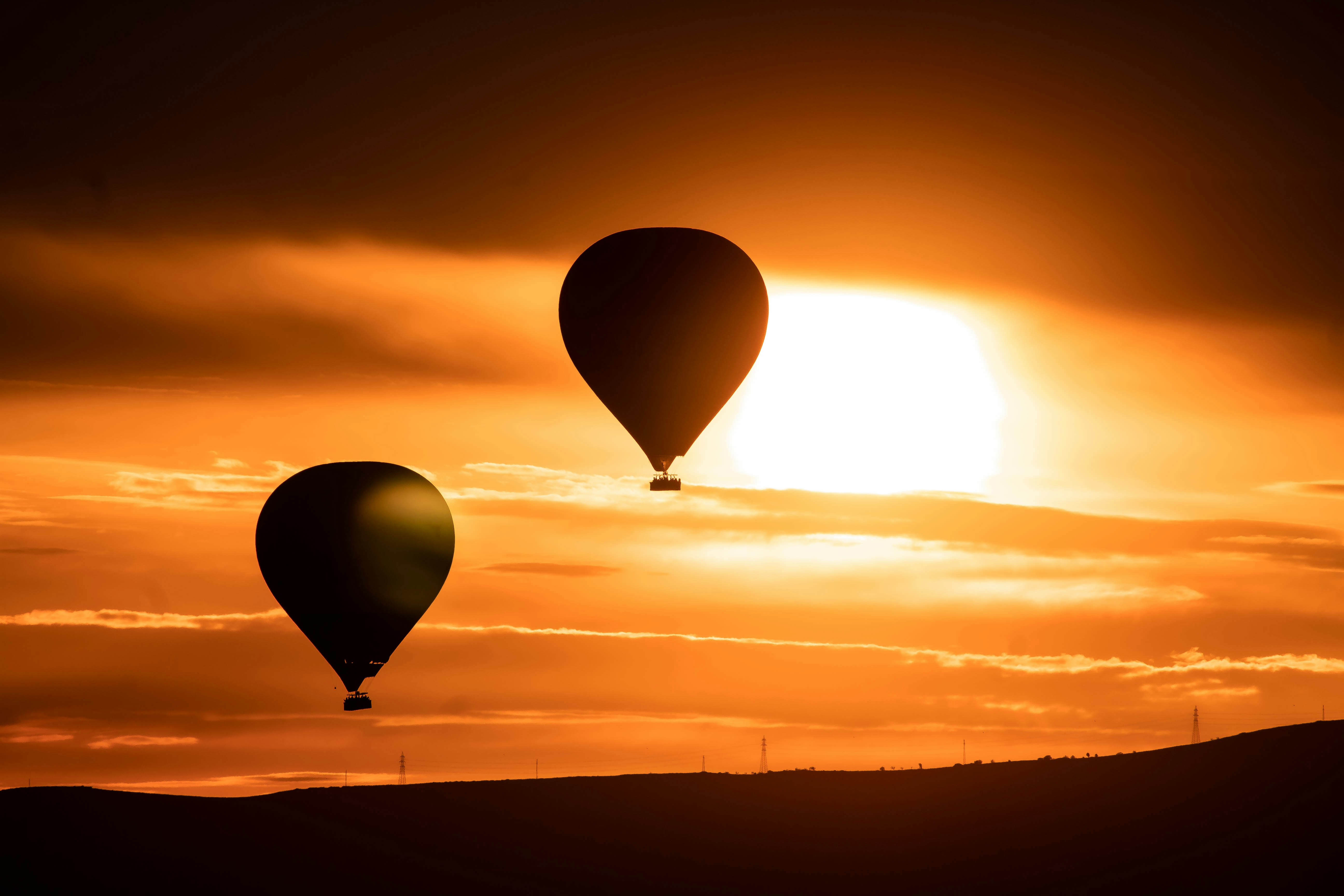 a couple of hot air balloons flying in the sky, Hot air balloons in Capadoccia, Turkey