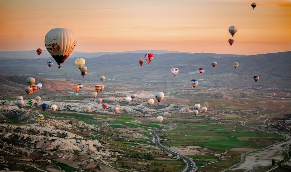 a bunch of hot air balloons flying in the sky