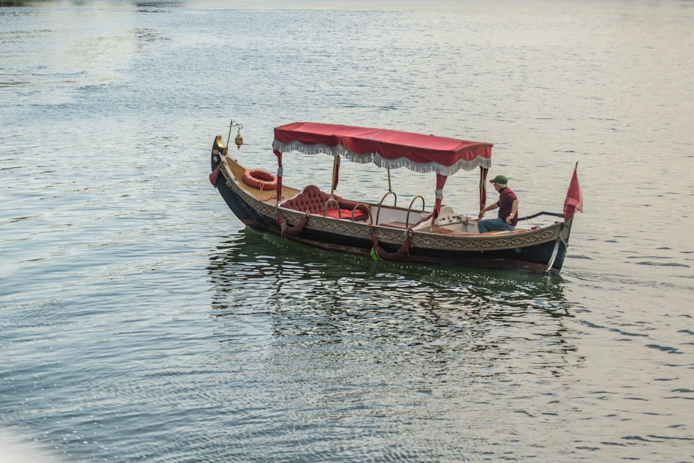 a small boat with a canopy on the water