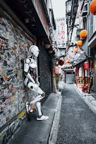 a robot standing next to a wall covered in stickers