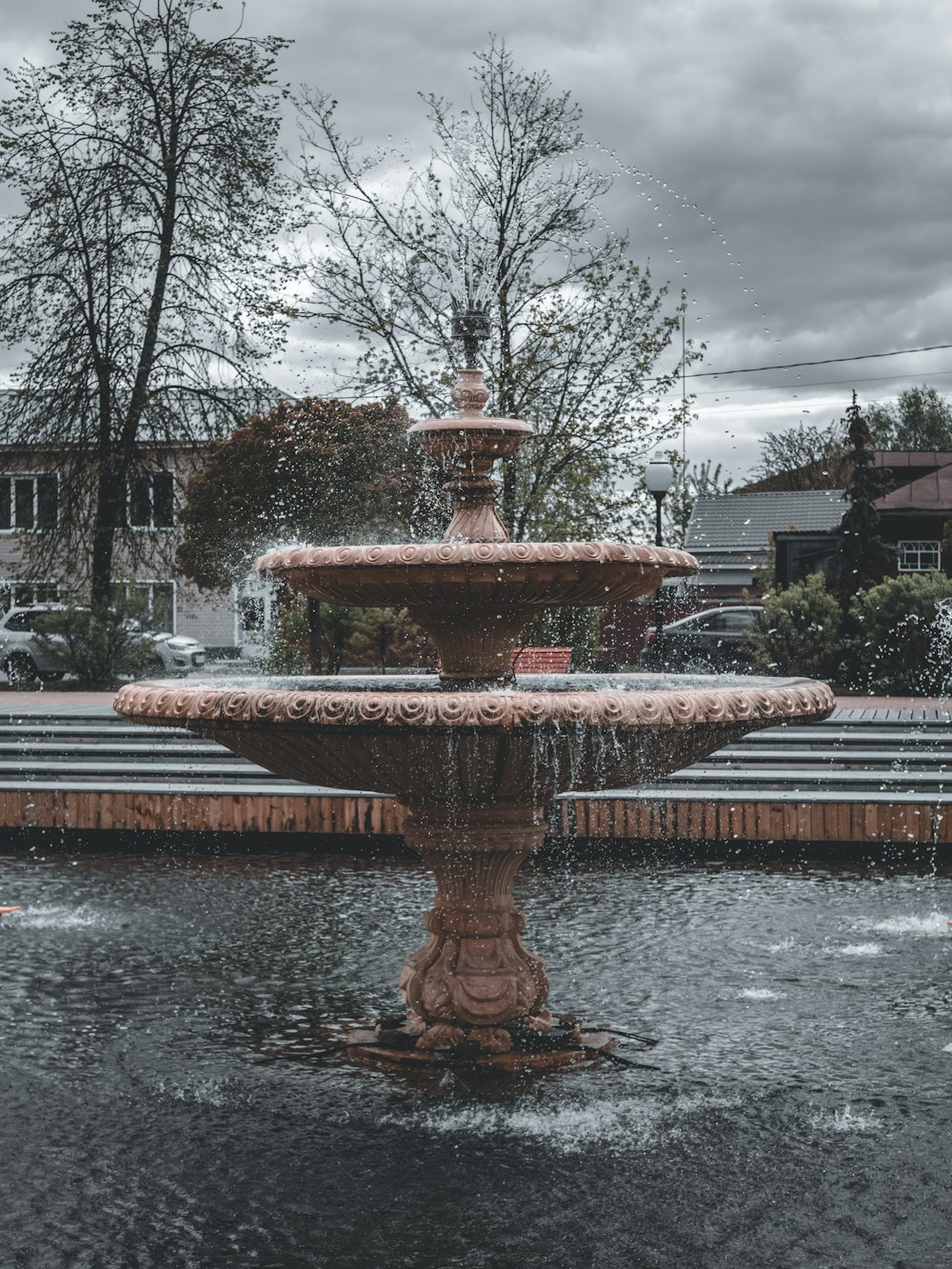 a water fountain in the middle of a park