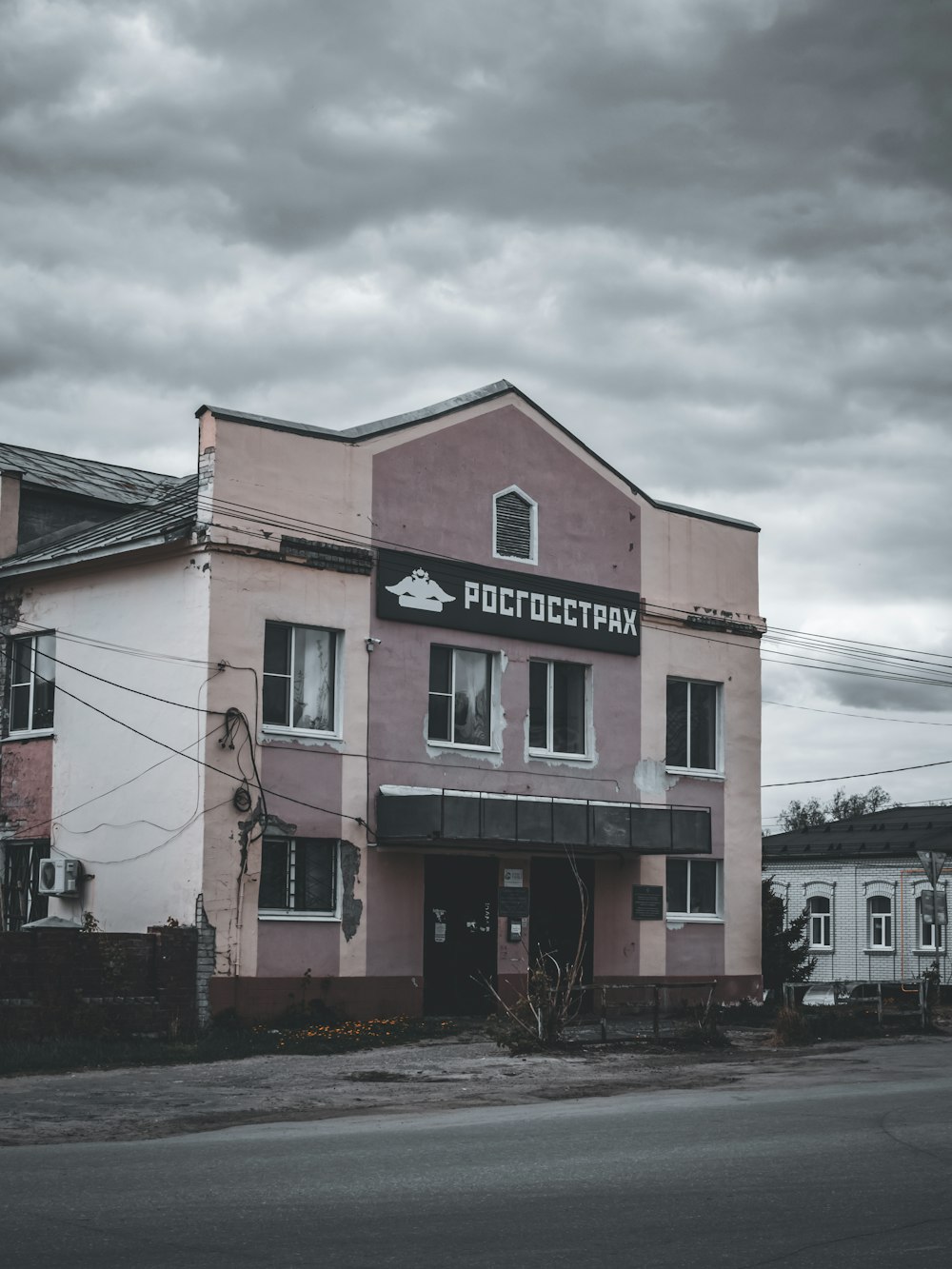 a pink building sitting on the side of a road