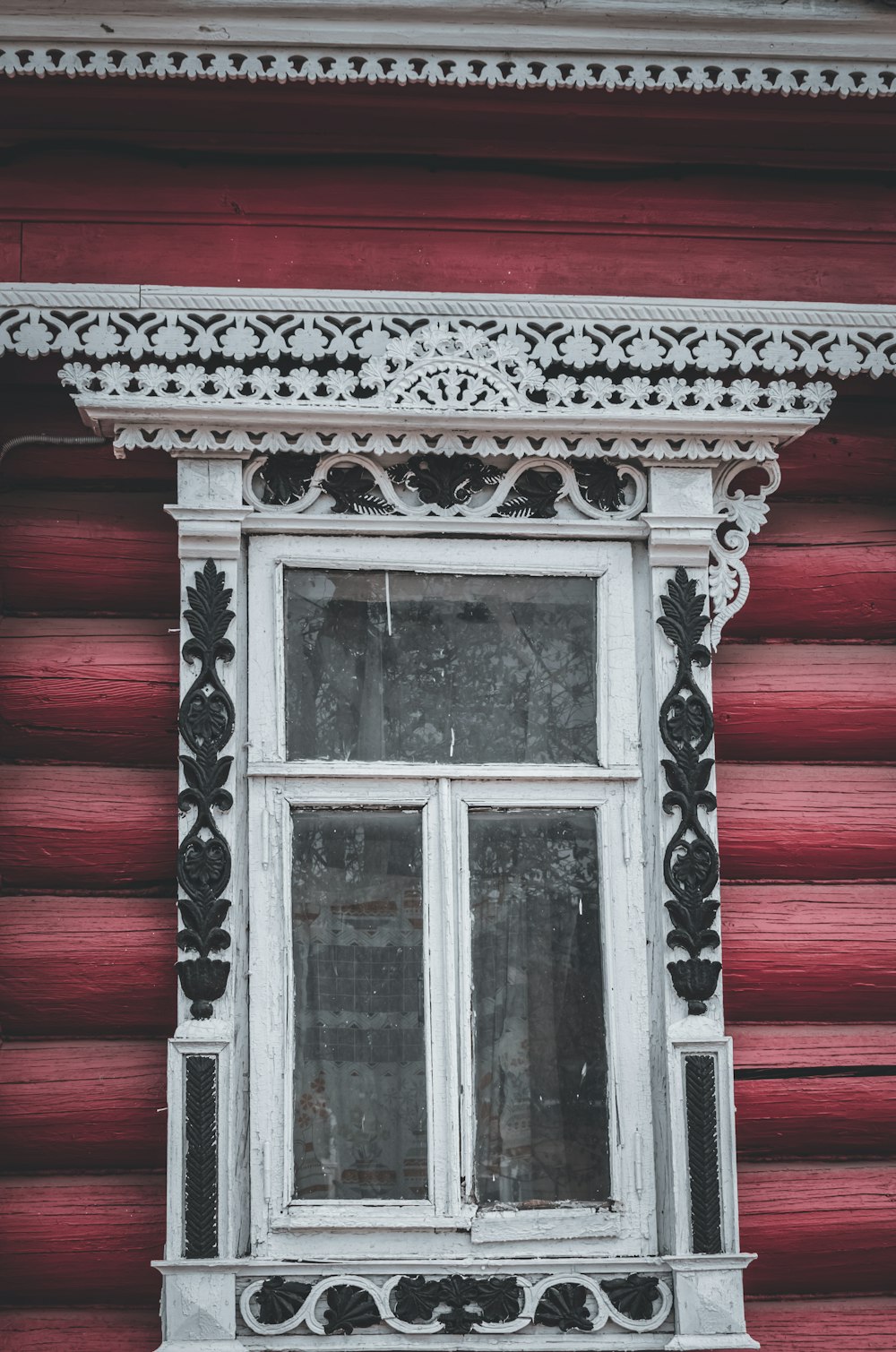 a red building with a white window on the side of it