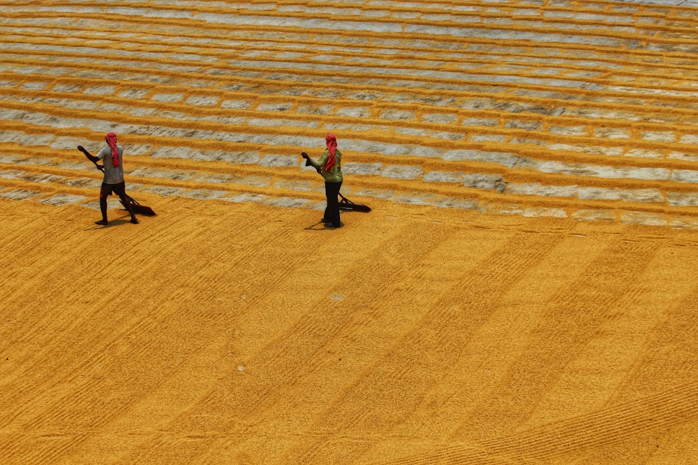 a couple of people that are standing in the dirt