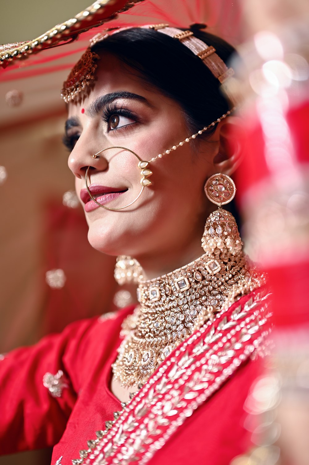 a woman wearing a red outfit and jewelry