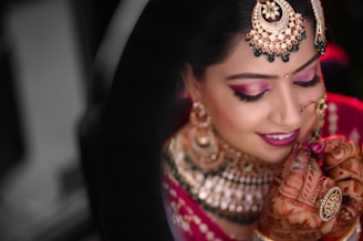 a woman in a red and gold bridal outfit