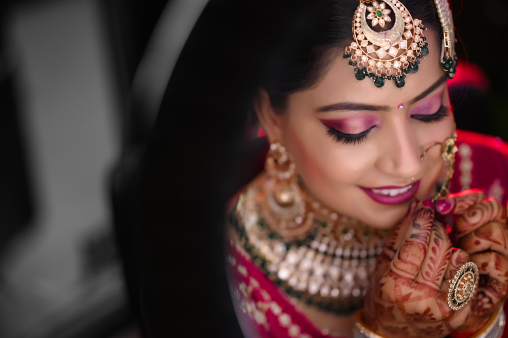 a woman in a red and gold bridal outfit