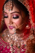 a woman in a bridal outfit with a nose ring