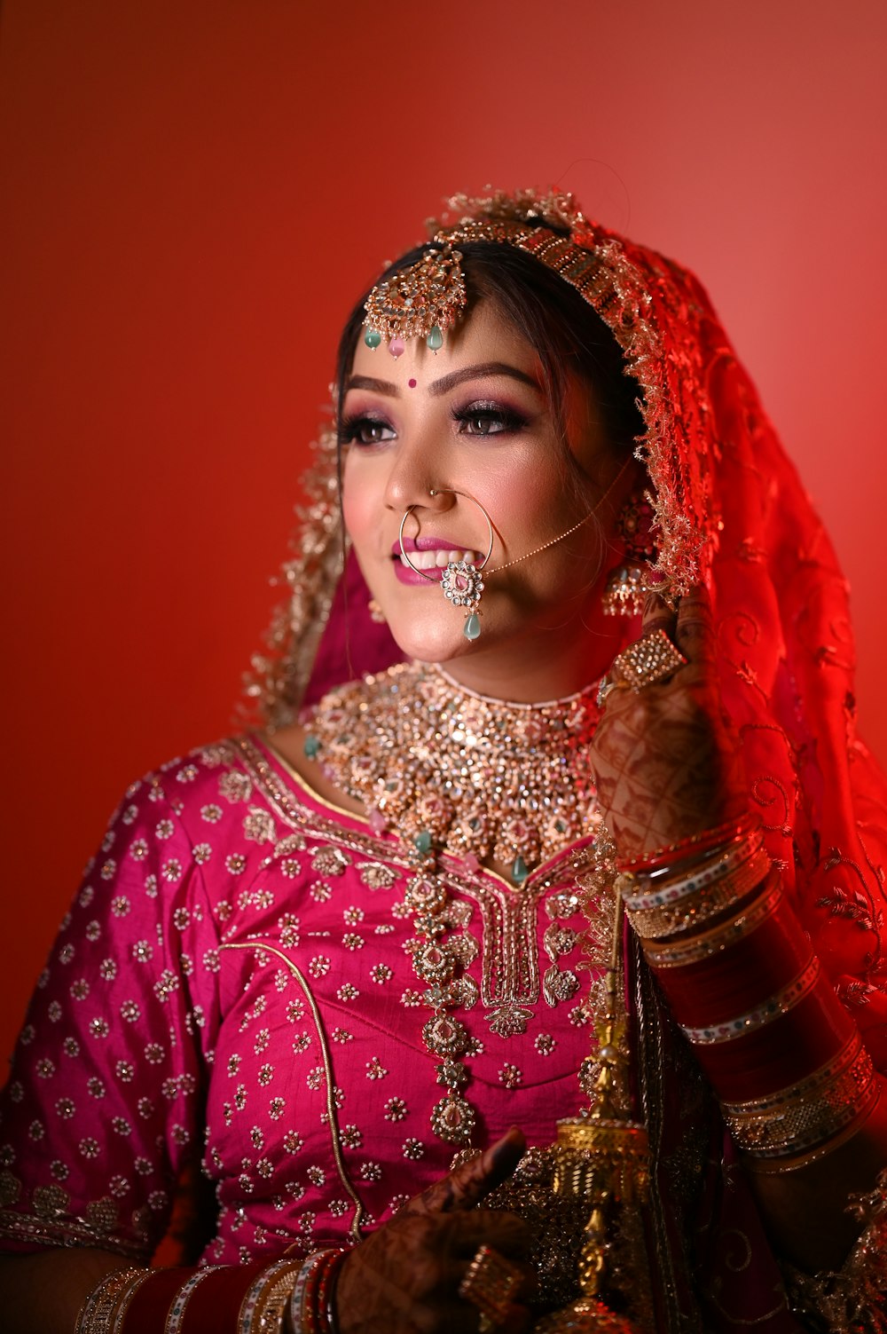 a woman in a pink outfit with a nose ring