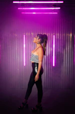 A vibrant city street scene featuring a model wearing Lumina Apparel’s sleek, purple-toned outfit.