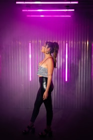 Photo of a model wearing a neo-purple and acid green accented t-shirt in an urban setting.