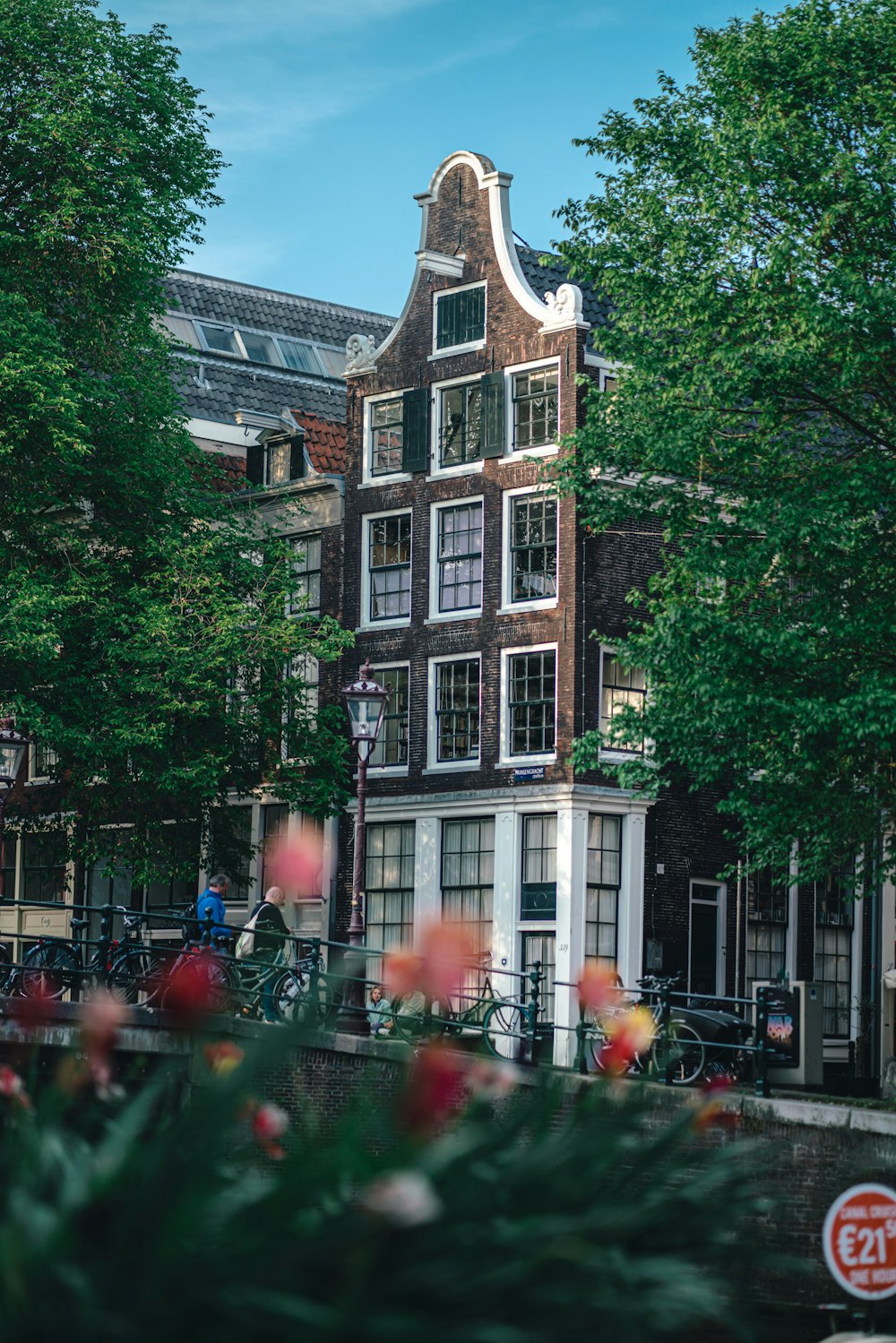 a tall building with lots of windows next to trees