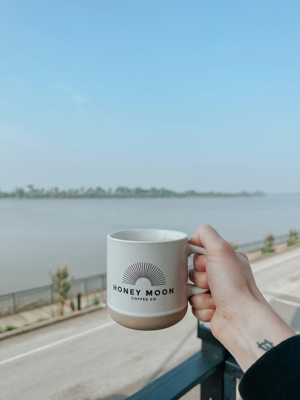 a person holding a coffee cup in their hand