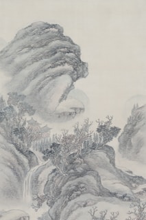 A traditional Asian landscape painting featuring towering, misty mountains and intricate foliage. A small pagoda-like structure is nestled among the trees near the base of the mountains, with a waterfall cascading down from the rocks above.