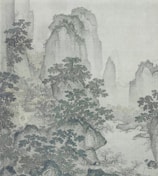 A traditional Chinese landscape painting depicting towering, rugged mountains shrouded in mist. Pine trees are scattered among the rocky terrain, and there appear to be small buildings or pavilions nestled in the forested areas. The scene conveys a sense of peace and solitude.