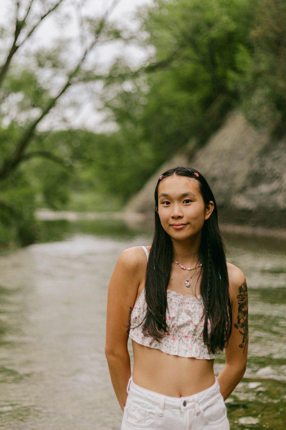 a woman standing in the middle of a river