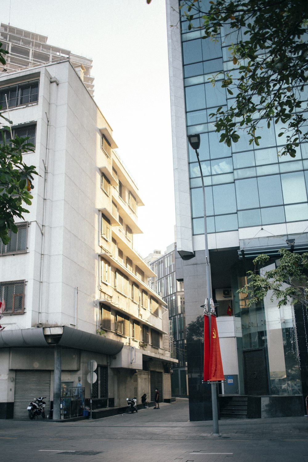 a tall white building sitting next to a tall building