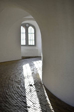 A serene hospital corridor bathed in natural light, emphasizing a calm and professional environment.
