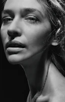 Monochrome portrait of a person in natural light, emphasizing texture and emotion.