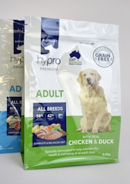 a bag of chicken and duck dog food next to a bag of chicken and duck