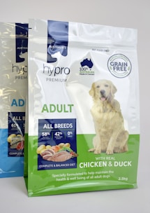 a bag of chicken and duck dog food next to a bag of chicken and duck