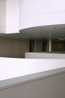 Minimalist hallway with smooth vinyl flooring and ambient recessed lighting.