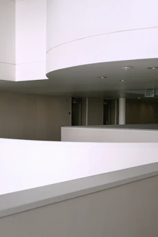 A modern condominium hallway with fresh paint and clean lines, highlighting maintenance work.