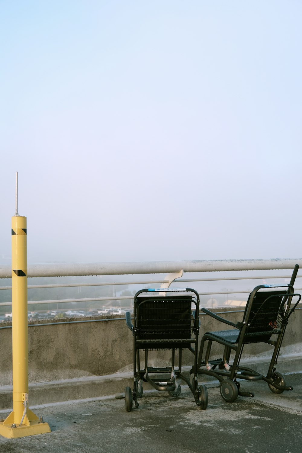 a couple of chairs sitting next to a yellow pole