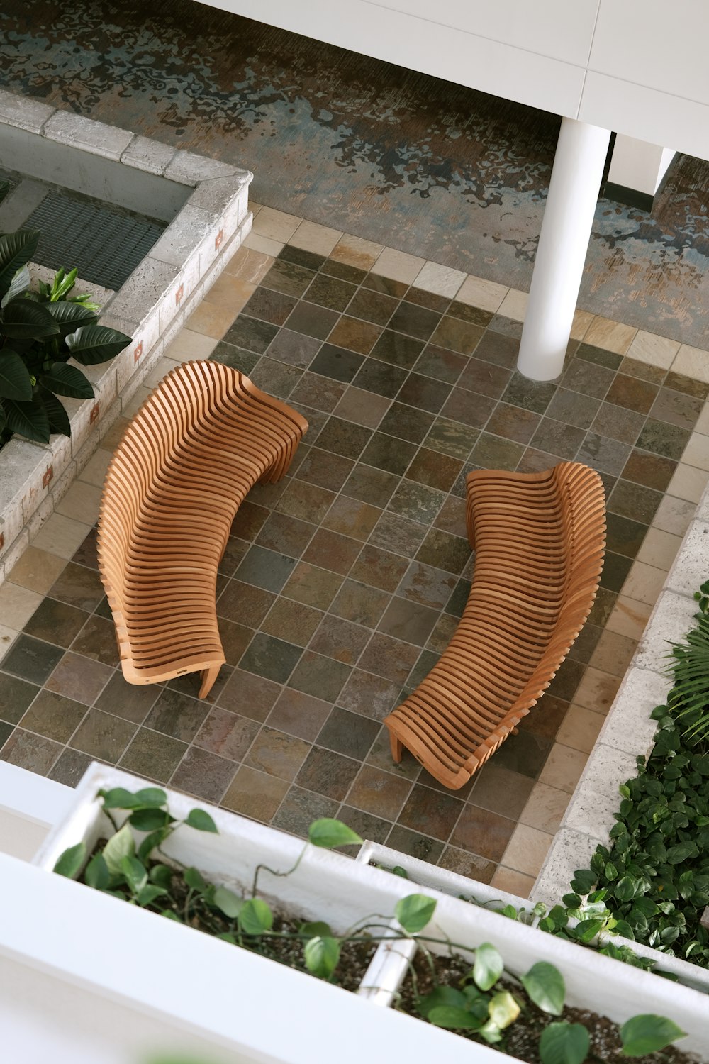 a couple of wooden benches sitting on top of a tiled floor