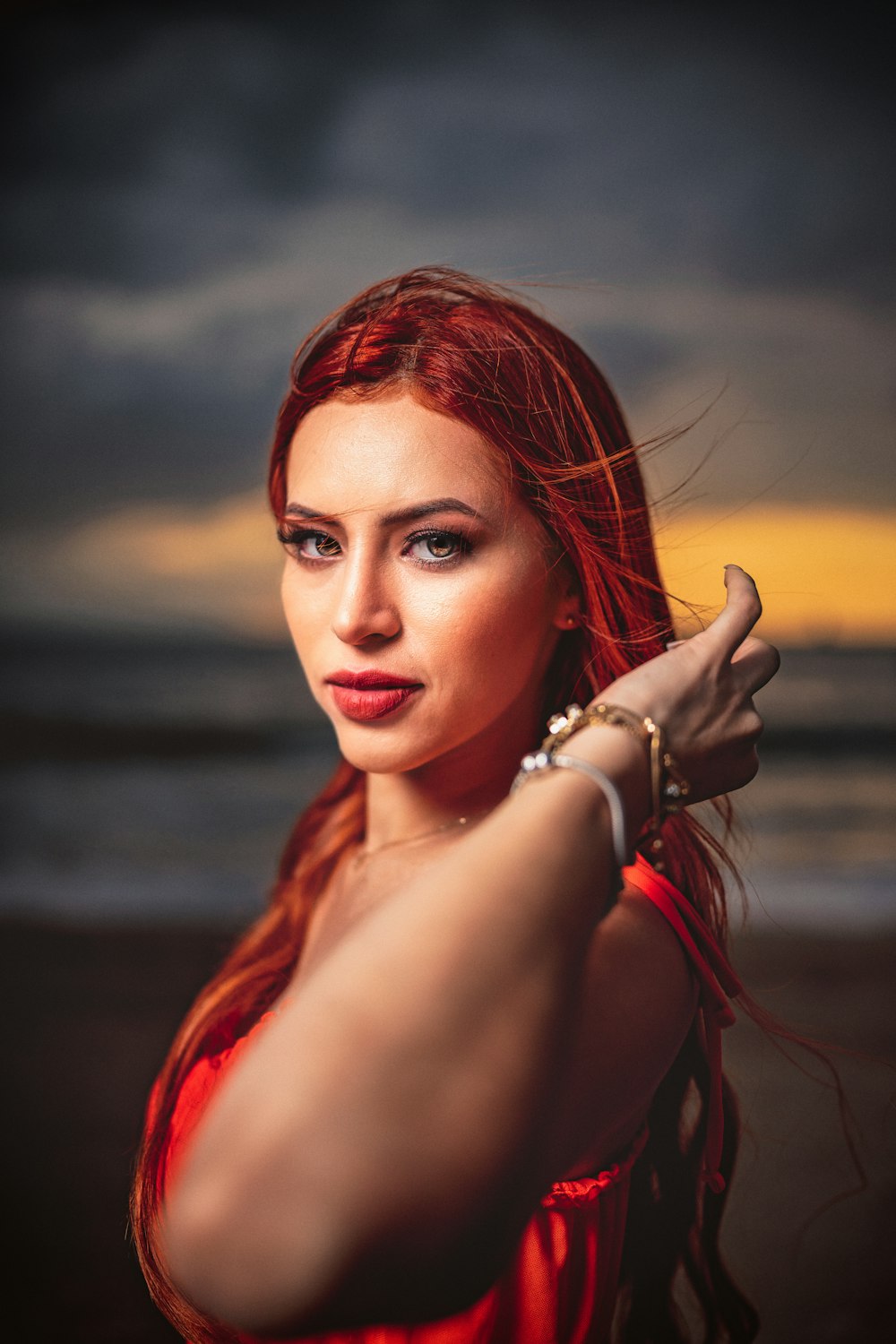 a woman in a red dress is posing for a picture