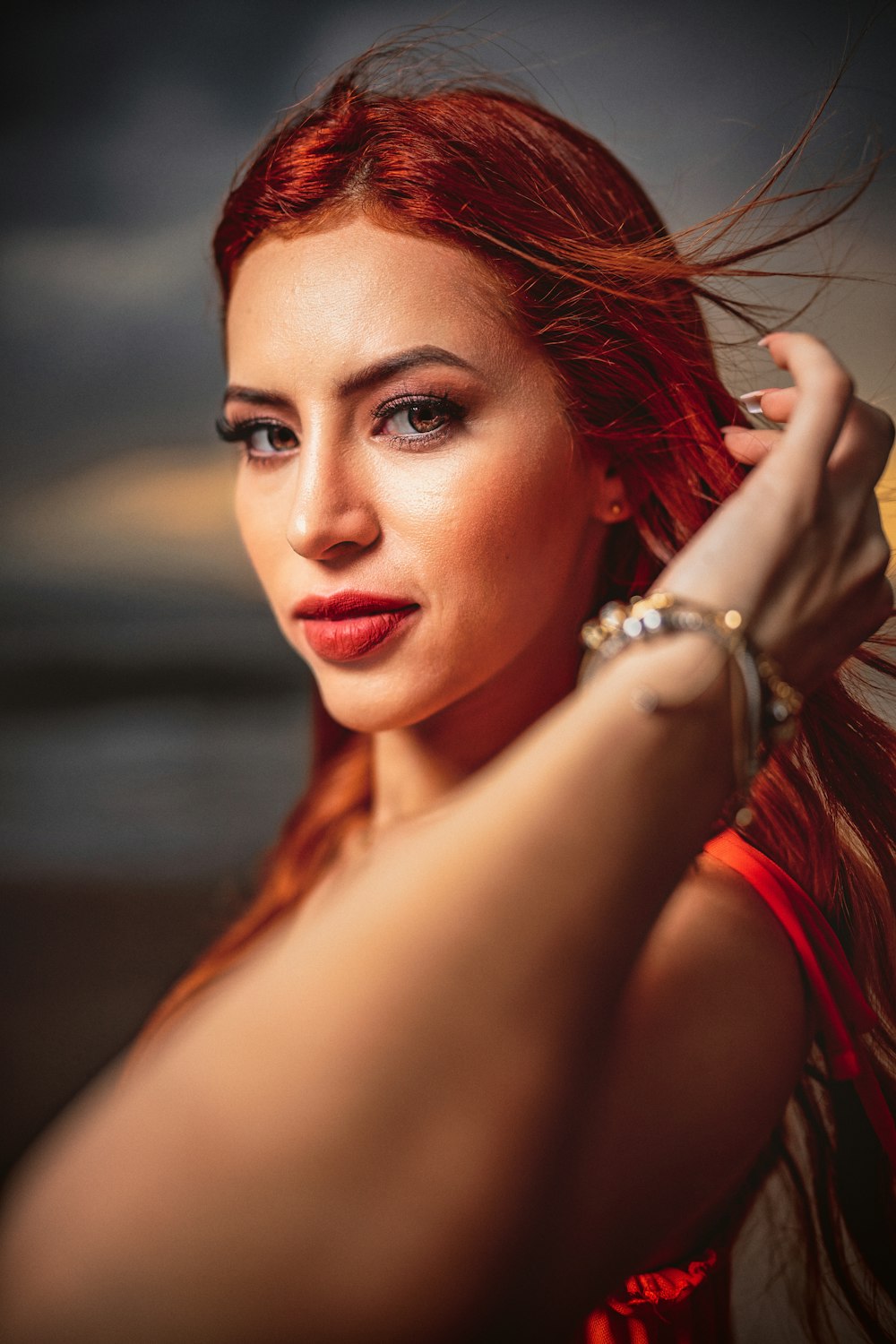 a woman with red hair is posing for a picture