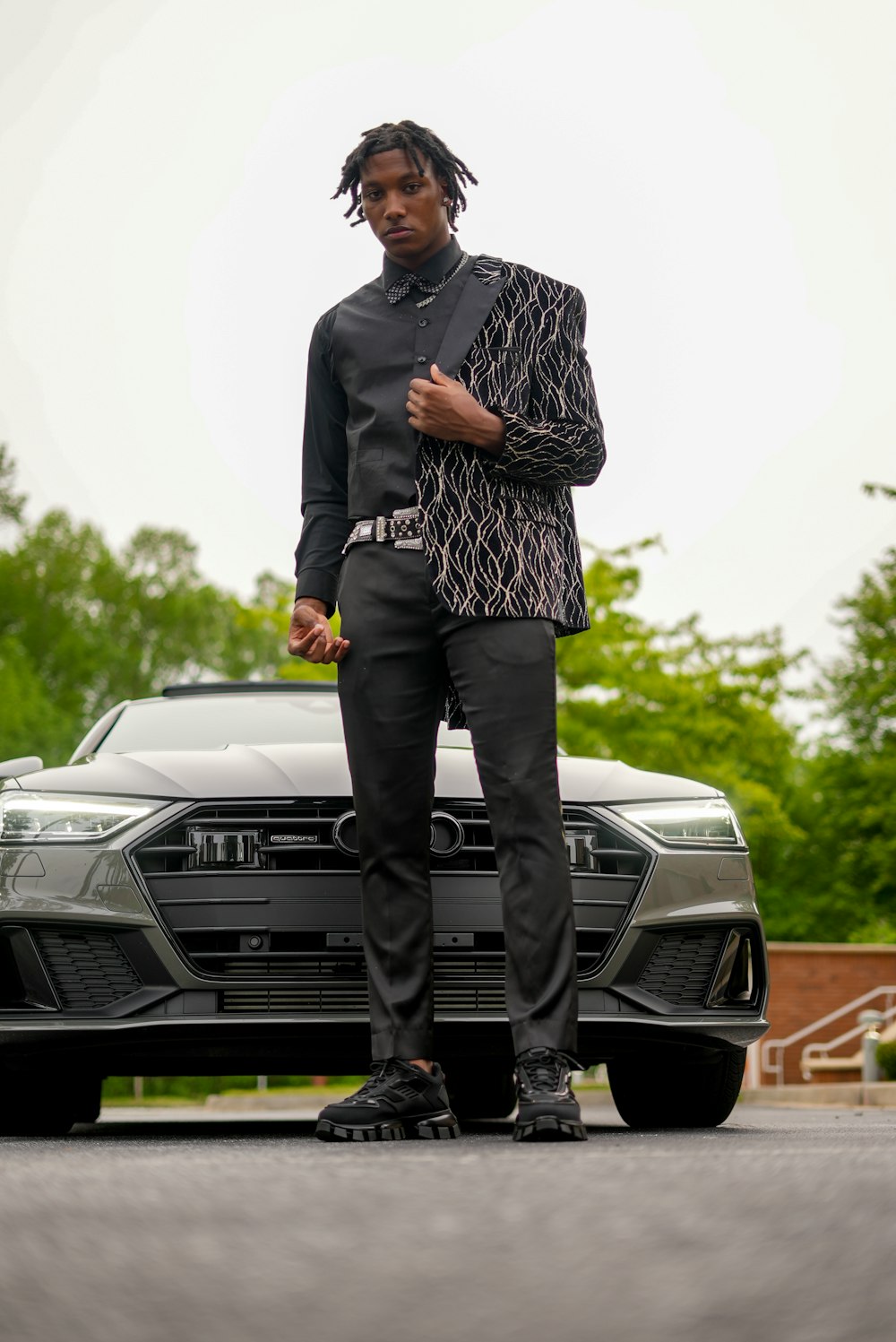 a man standing in front of a car