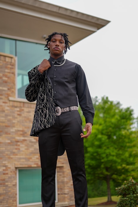 A stylish man wearing a casual outfit from strakorsfashion, standing confidently outdoors.