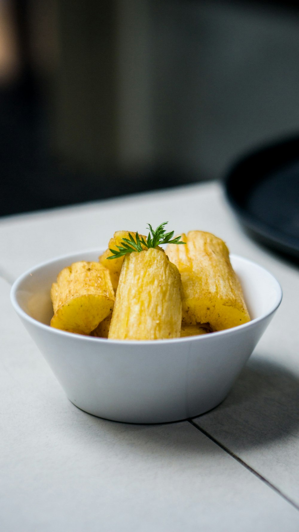 a white bowl filled with food on top of a table