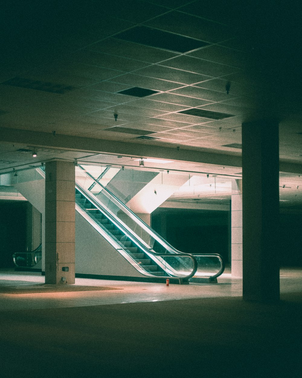 an empty parking garage with an escalator
