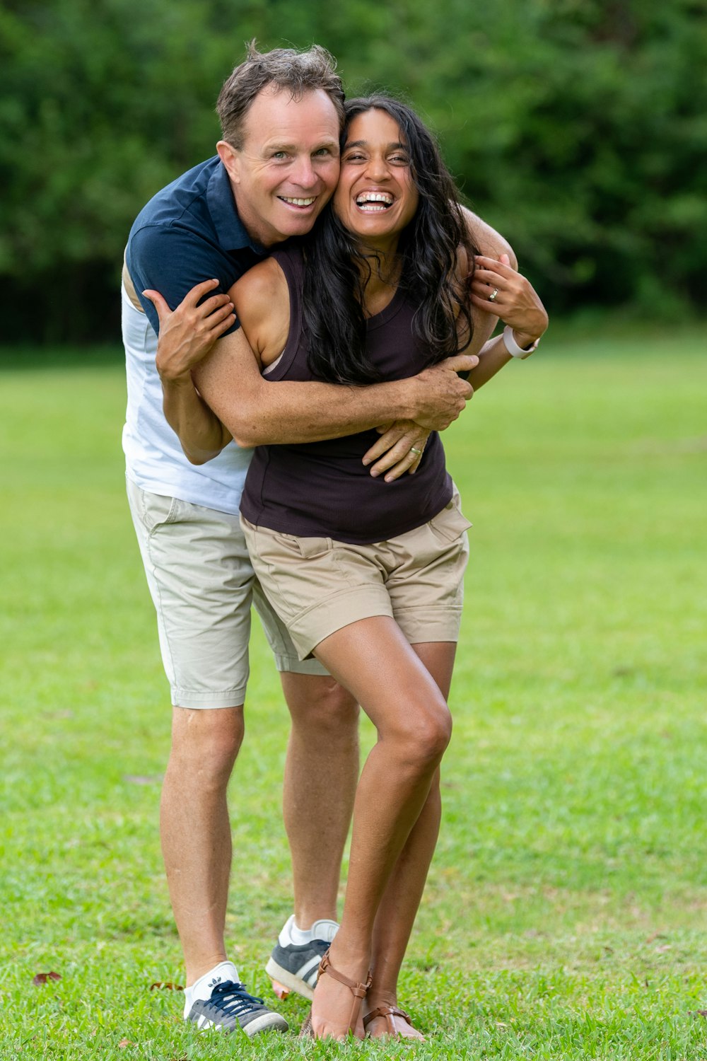 a man hugging a woman in a field