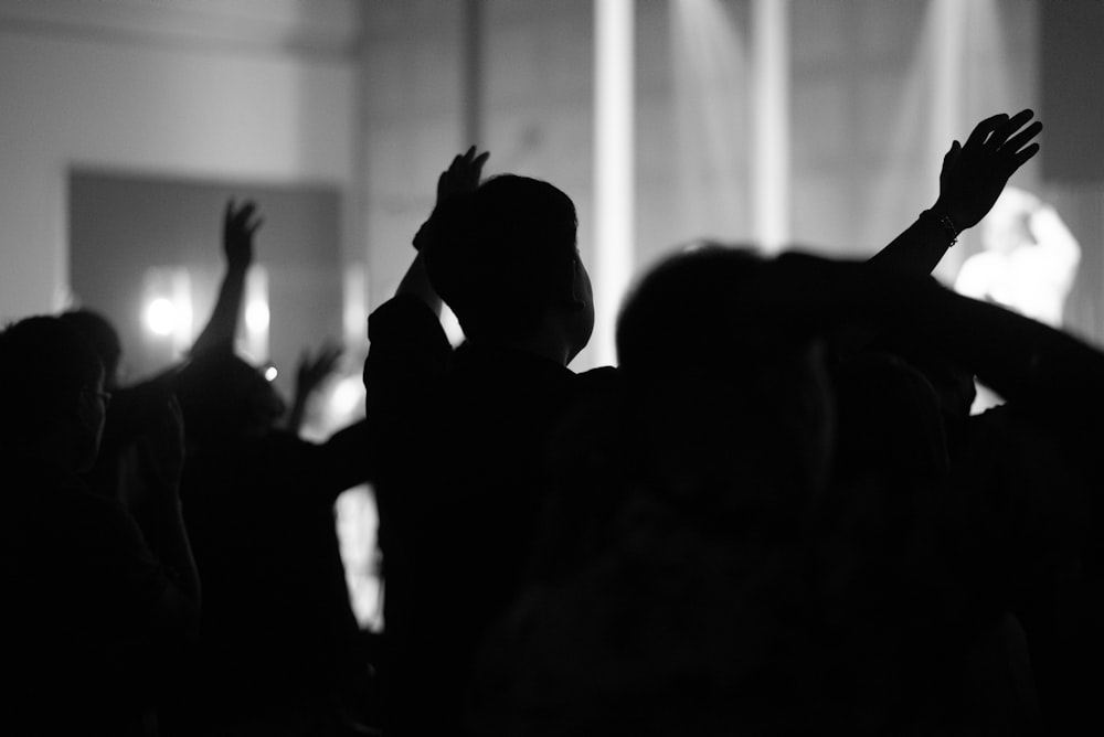 a group of people raising their hands in the air