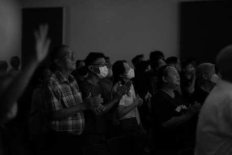 A vibrant image of a group praying together in unity.