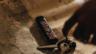 Close-up of detailed cadastral maps spread out on a table with drafting tools.