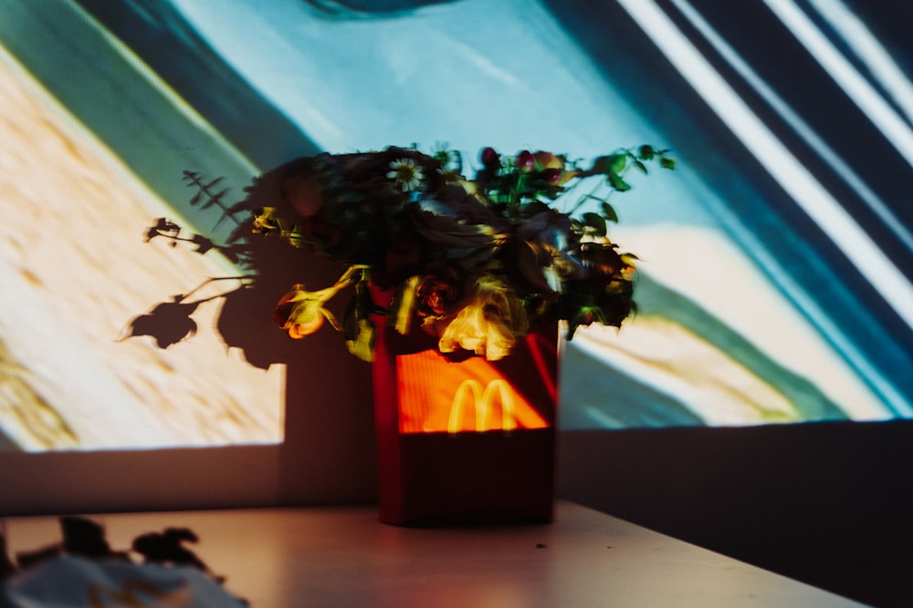 a vase filled with flowers sitting on top of a table