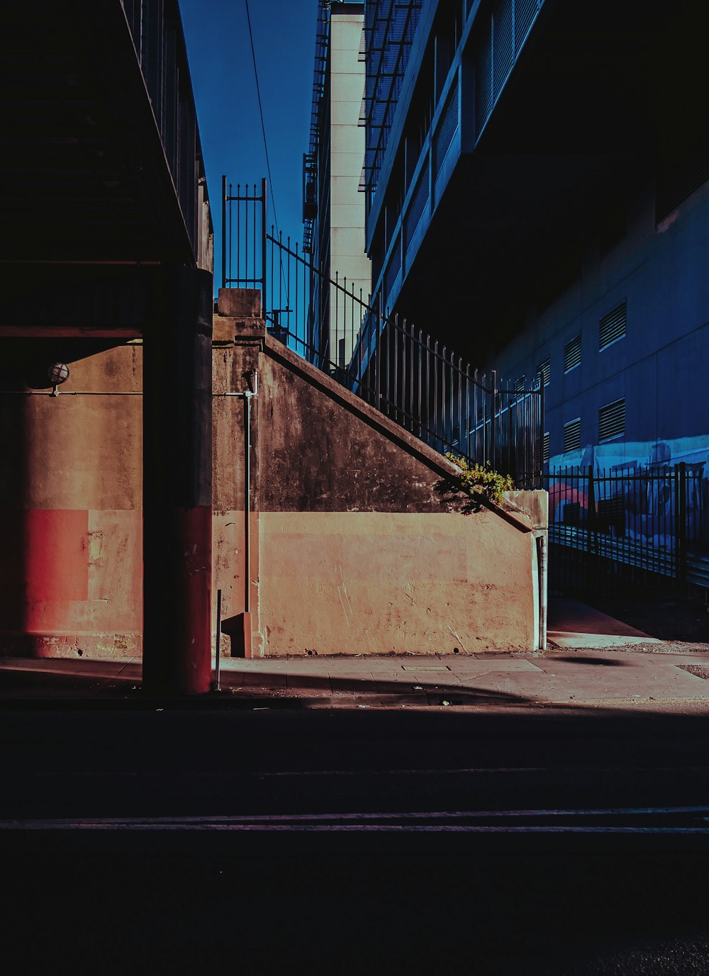 an empty street with a building in the background