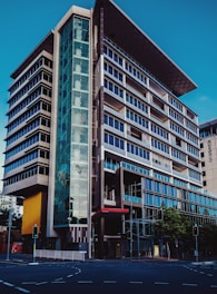 A sleek modern office building with integrated smart lighting and security systems visible.