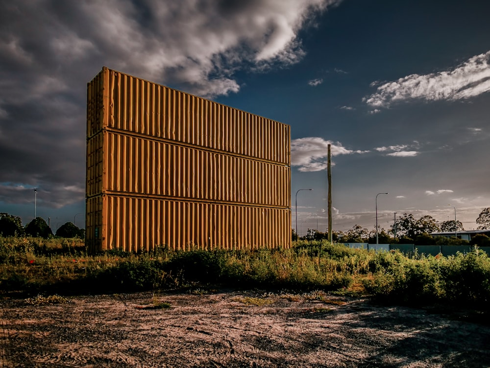 a large wooden structure sitting in the middle of a field