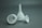 Three white funnels of varying sizes are placed on a gray surface. The largest funnel is upright, while the other two are placed horizontally.