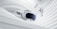 A virtual reality headset and two controllers are suspended against a backdrop of smooth, swirling white fabric, evoking a sense of fluidity and modern technology.