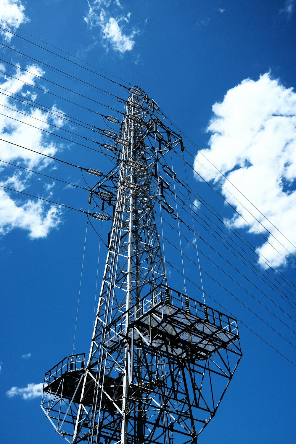 a tall tower with lots of wires on top of it