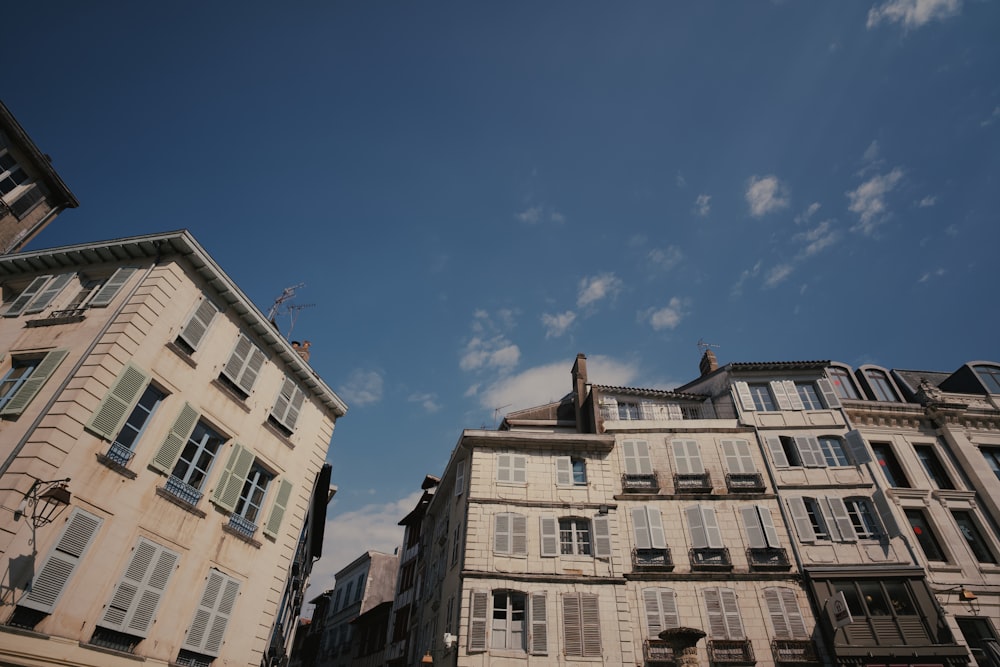 a group of buildings with windows and shutters